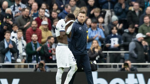 Tottenham Hotspur midfielder Pape Matar Sarr pictured walking off the field with his jersey covering his face after picking up an injury during a Premier League game against Bournemouth on New Year's Eve in December 2023